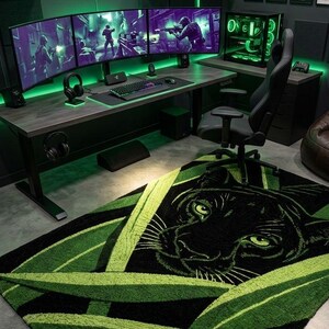 May include: A modern gaming room with a black and green color scheme. The room features a desk with three curved monitors, a gaming chair, and a rug with a panther design. The wall has the neon sign "PAW-SITIVE GAMING".