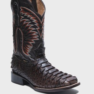 May include: A dark brown cowboy boot featuring a textured, scale-like leather vamp and a tall shaft with intricate red and white flame-patterned stitching. The boot has a square toe, a stacked heel, and pull tabs at the top of the shaft.