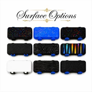 May include: Nine rectangular cases with various surface designs, including speckled, patterned, and textured finishes. The cases have black or white frames with blue clasps. The text "Surface Options" is displayed above the cases.