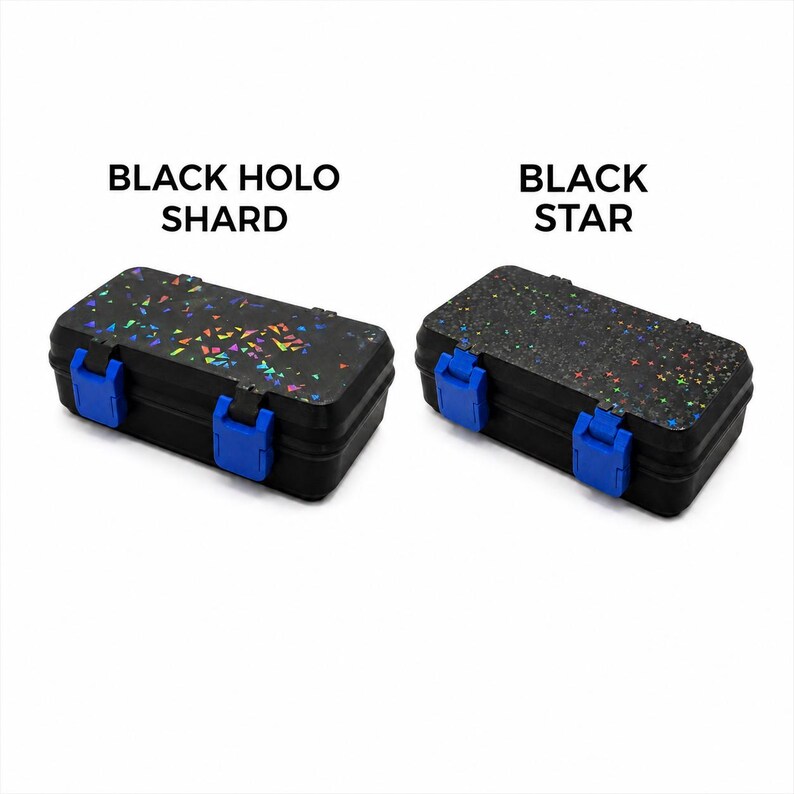 May include: Two black rectangular storage boxes with blue clasps. One box is labeled "BLACK HOLO SHARD" and has a holographic shard pattern. The other box is labeled "BLACK STAR" and has a star pattern.