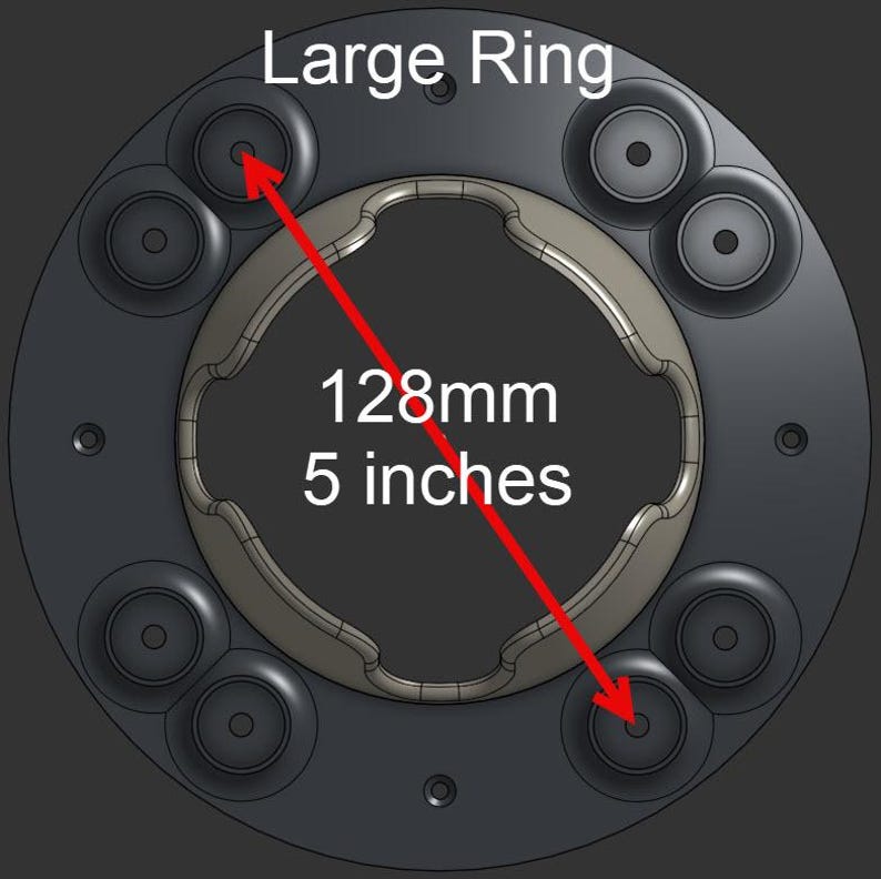 May include: A dark gray circular component labeled Large Ring with a central wavy cutout and eight small circular mounting points. A red arrow indicates a diameter measurement of 128mm or 5 inches across the object on a dark background.