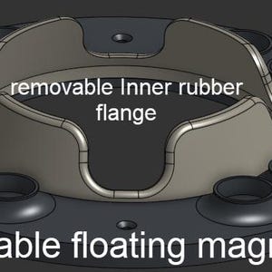 May include: A swappable floating magnet ring featuring a removable inner rubber flange. The circular black base includes multiple recessed circular openings arranged around the center, which holds the light gray, curved, four-pronged component.