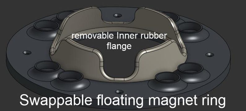 May include: A swappable floating magnet ring featuring a removable inner rubber flange. The circular black base includes multiple recessed circular openings arranged around the center, which holds the light gray, curved, four-pronged component.