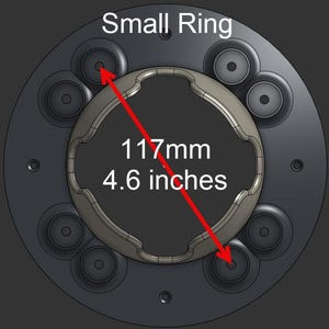 May include: A circular black component labeled Small Ring with a central metallic insert featuring a wavy edge. A red arrow indicates a diameter measurement of 4.6 inches between two circular mounting points on the dark gray base plate.