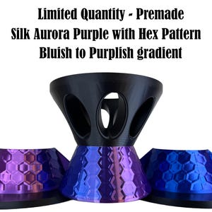 May include: A set of three objects with a black top section featuring oval cutouts and a base with a hexagonal pattern. The base displays a gradient from blue to purple. Text reads: Limited Quantity - Premade Silk Aurora Purple with Hex Pattern Bluish to Purplish gradient.
