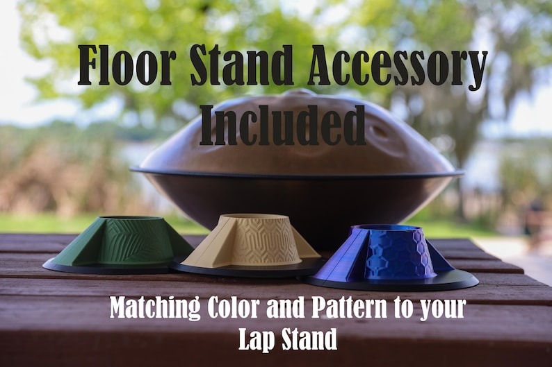 May include: A brown steel tongue drum sits behind three conical stands in green, beige, and blue, each featuring distinct geometric patterns. Text reads: Floor Stand Accessory Included. Matching Color and Pattern to your Lap Stand.