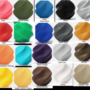 May include: A collection of twenty spherical objects with a spiraling, twisted surface texture, displayed in a grid. Each object is a solid, distinct color including pink, olive green, marine blue, black, silver, red, green, blue, dark gray, gold, orange, turquoise, dark purple, light gray, bronze, yellow, lemon yellow, cocoa brown, white, and desert tan.