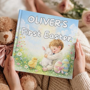 May include: A children's book titled "OLIVER'S First Easter" features a pastel illustration of a child hugging a white bunny. A yellow chick and decorated Easter eggs are also shown. A brown teddy bear with a pink bow is next to the book.