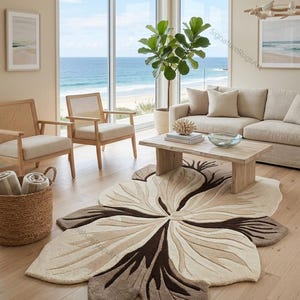 May include: An area rug featuring a large, organic, flower-like shape with layered petals in shades of cream, beige, and dark brown. The rug has a textured, tufted surface with carved details that define the petal edges and central core.