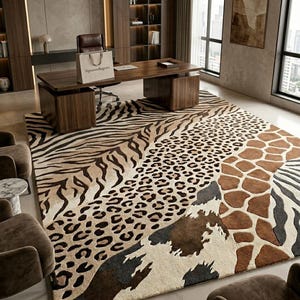 May include: A large area rug with a patchwork design featuring animal print patterns. The rug includes zebra stripes, leopard spots, giraffe patterns, and cowhide patches in shades of brown, tan, and black. The rug is placed in an office setting with a wooden desk and chair.