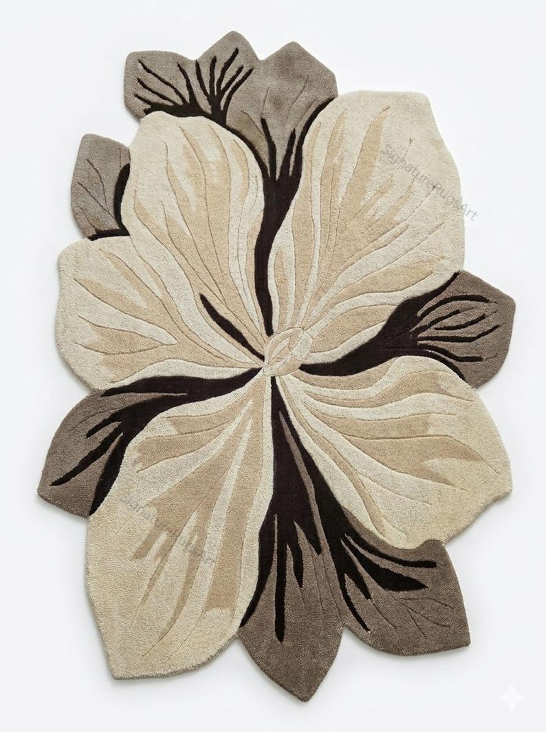 May include: A tufted rug shaped like a large flower with irregular, organic petals. The design features a color palette of cream, beige, and dark brown, with deep brown lines radiating from the center. The text SignatureRugsArt is visible.