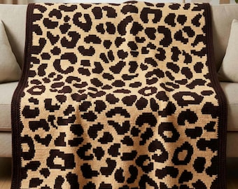 May include: A rectangular crochet blanket featuring a repeating dark brown leopard print pattern on a light beige background. The blanket has a solid dark brown border along all four edges. The text "happyhookclub" is printed in white at the bottom.