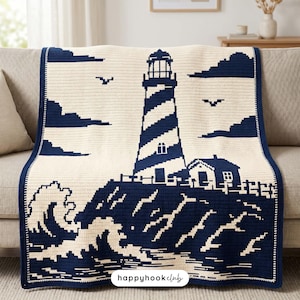 May include: A cream and navy blue crochet blanket featuring a lighthouse, a small house, and crashing waves. The design includes pixelated clouds and birds in the sky. A white rectangular label with the text happyhookclub is at the bottom.