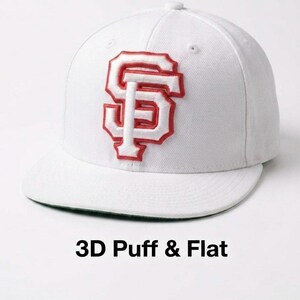 May include: White baseball cap with a flat brim and a red and white embroidered "SF" logo. The cap has a structured crown and a curved bill. The text "3D Puff & Flat" is printed at the bottom of the image.