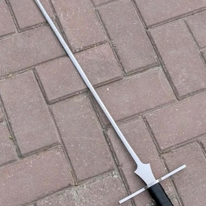May include: A long, slender steel sword featuring a straight, double-edged blade that tapers to a point. The sword includes a simple, straight crossguard, a black wrapped handle, and a polished silver-coloured pommel at the base of the grip.