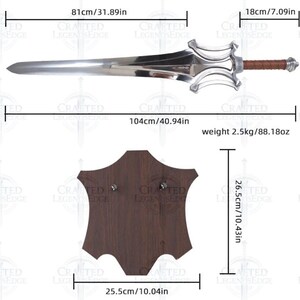 May include: A silver-colored sword with a brown leather grip and a decorative hilt. The sword is 104cm/40.94in long and weighs 2.5kg/88.18oz. A dark brown wooden display stand is also included, measuring 25.5cm/10.04in wide and 26.5cm/10.43in high.