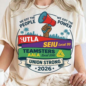 Labor movement PNG union strong workers rights protest design featuring a raised fist holding a red megaphone above a city skyline with palm trees, layered banners displaying UTLA SEIU Teamsters AALA and “Union Strong 2026” text, bold modern activist style with vibrant red, teal, green, and yellow colors, ideal for shirt sublimation, protest apparel, and digital download PNG file for union supporters and activists
