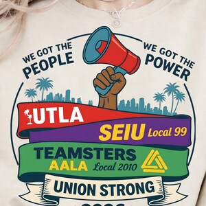 Labor movement PNG union strong workers rights protest design featuring a raised fist holding a red megaphone above a city skyline with palm trees, layered banners displaying UTLA SEIU Teamsters AALA and “Union Strong 2026” text, bold modern activist style with vibrant red, teal, green, and yellow colors, ideal for shirt sublimation, protest apparel, and digital download PNG file for union supporters and activists