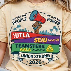 Labor movement PNG union strong workers rights protest design featuring a raised fist holding a red megaphone above a city skyline with palm trees, layered banners displaying UTLA SEIU Teamsters AALA and “Union Strong 2026” text, bold modern activist style with vibrant red, teal, green, and yellow colors, ideal for shirt sublimation, protest apparel, and digital download PNG file for union supporters and activists