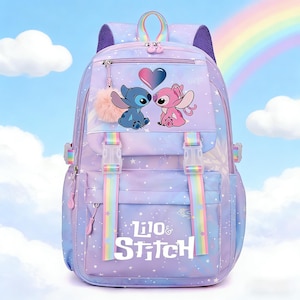 May include: A purple and blue backpack featuring the characters Stitch and Angel with a heart graphic. The backpack has rainbow straps, a fluffy pink pom-pom, and the words "Lilo & Stitch". The background shows a rainbow and stars.