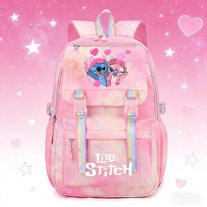 May include: Pink backpack featuring Stitch and Angel characters, with a fluffy pom-pom and rainbow accents. The backpack has adjustable straps, a top handle, and the words "Lilo & Stitch" printed on the front. The background is a pink gradient with stars and hearts.