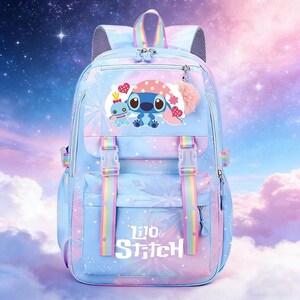 May include: A light blue backpack with a colorful design featuring the characters Stitch and Angel. The backpack has adjustable rainbow straps, a top handle, and the words "Lilo & Stitch" printed on the front. A pink pom-pom hangs from the zipper.