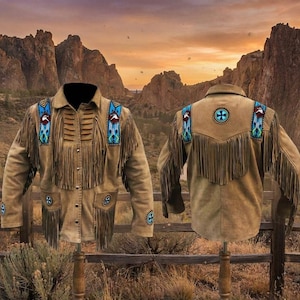 May include: A tan suede jacket with fringe and colorful beaded accents. The jacket features a collared neckline, button-down front, and pockets. The shoulders and pockets are decorated with turquoise, red, and white beading. The back of the jacket has a cross design.