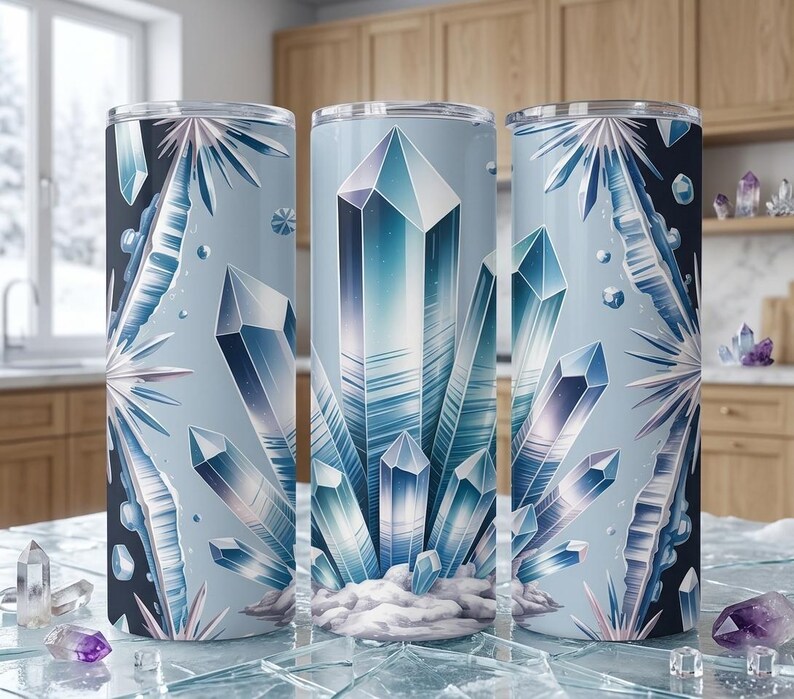 May include: Three stainless steel tumblers with a crystal design. The tumblers have a light blue background with illustrations of blue and white crystals. The design wraps around the entire tumbler. Each tumbler is approximately 20 cm tall.