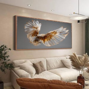 May include: A framed canvas print depicting a bird in flight with outstretched wings. The artwork shows detailed wings, with white, brown, and gold feathers against a grey background. The frame has a copper finish.