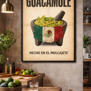 May include: A framed poster featuring the word "GUACAMOLE" above an image of guacamole in a molcajete. The molcajete is draped with the Mexican flag. The text "HECHO EN EL MOLCAJETE" is below the image. The poster is displayed in a rustic dining room.