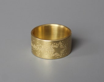 wide golden band ring with shooting star design