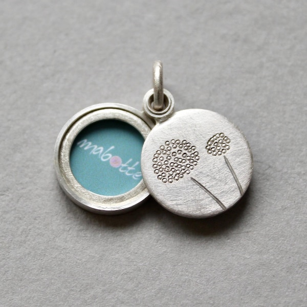 handmade round photo locket with delicate dandelions in sterling silver