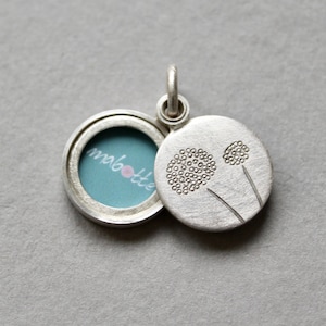 handmade round photo locket with delicate dandelions in sterling silver