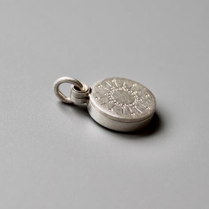 tiny silver picture locket with sun design image 3