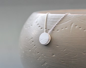 Small reversible pendant necklace with waves in sterling silver