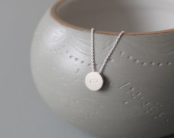 Minimalist pendant necklace in sterling silver with infinity symbol