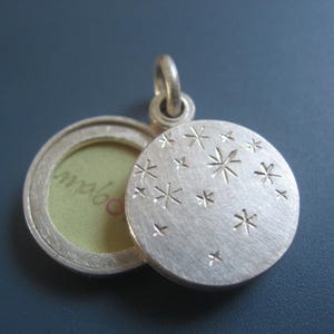small double sided locket with starry night design in sterling silver
