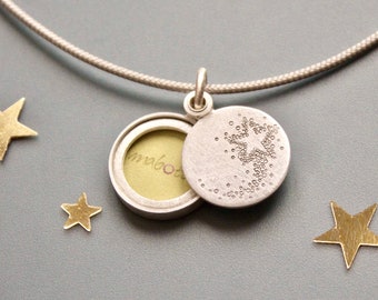 small silver picture locket with a shooting star