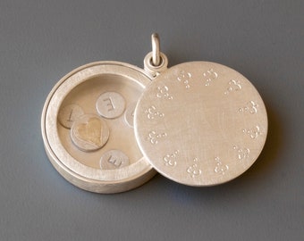 handmade silver living locket with delicate edging and secret message