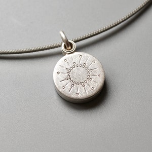 tiny silver picture locket with sun design image 2