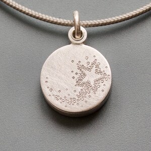 small silver picture locket with a shooting star image 2