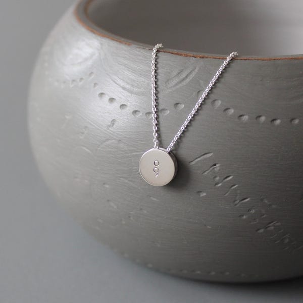 Small silver reversible pendant with semicolon