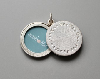 elegant silver locket for two pictures with classic dots pattern