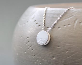 Small reversible pendant necklace with waves in sterling silver