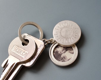 silver keychain locket for two pictures with sun decor