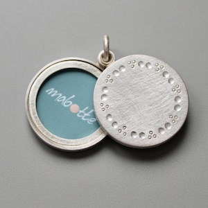 elegant silver locket for two pictures with classic dots pattern