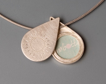 teardrop picture locket with handstamped sun in sterling silver