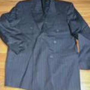 May include: A dark navy blue blazer featuring a subtle vertical pinstripe pattern. This garment includes a notched lapel, long sleeves, and a double-breasted front closure with four visible buttons arranged in two columns, plus additional buttons on the cuffs.