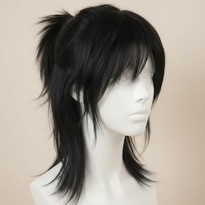 May include: A black wig styled with a layered, shaggy cut and a small ponytail at the back. The wig features long, face-framing layers and bangs. The wig is displayed on a white mannequin head.