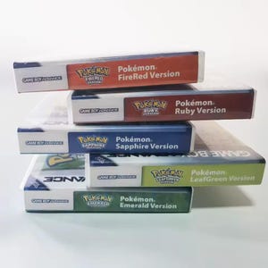 May include: A stack of five Game Boy Advance video game cartridges. The cartridges are labeled "Pokémon FireRed Version", "Pokémon Ruby Version", "Pokémon Sapphire Version", "Pokémon LeafGreen Version", and "Pokémon Emerald Version". The cartridges are in their original packaging.
